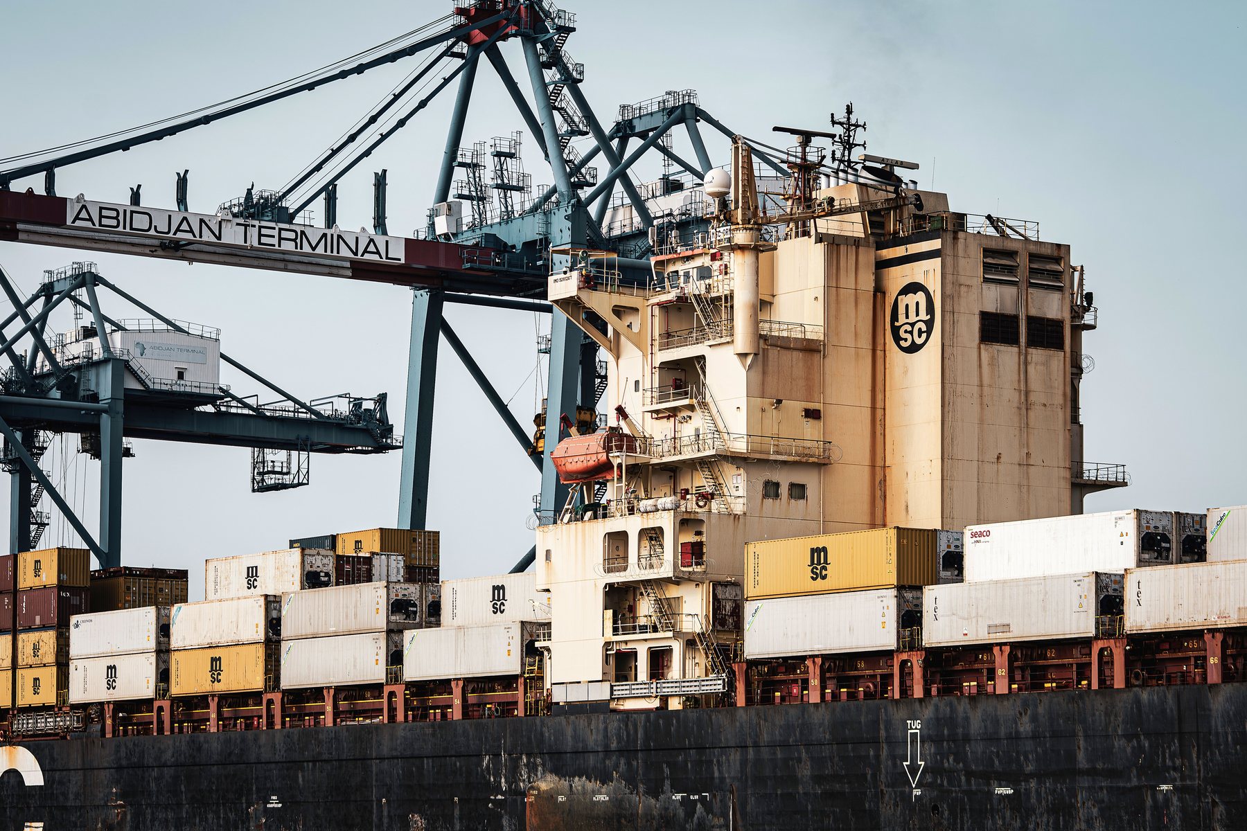 Container vessel and cargo cranes at Abidjan Terminal, Côte d’Ivoire.